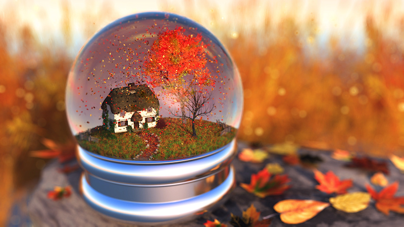 Inside a 'snow globe' is an autumn landscape with a cottage overshadowed by maple and cherry trees. The surrounding field is filled with tall green and golden grass. Roses and ivy climb the wall of the little house. The maple tree is in brilliant fall color, and instead of snow there are maples leaves in shades of red, orange, and yellow swirling around in the globe and blanketing the grass.