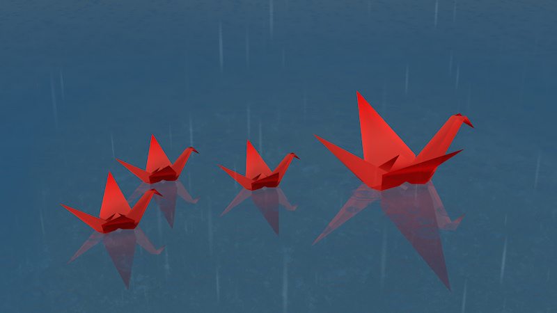 A family of red origami cranes floats across the still water of a pool while the raindrops splash around them.